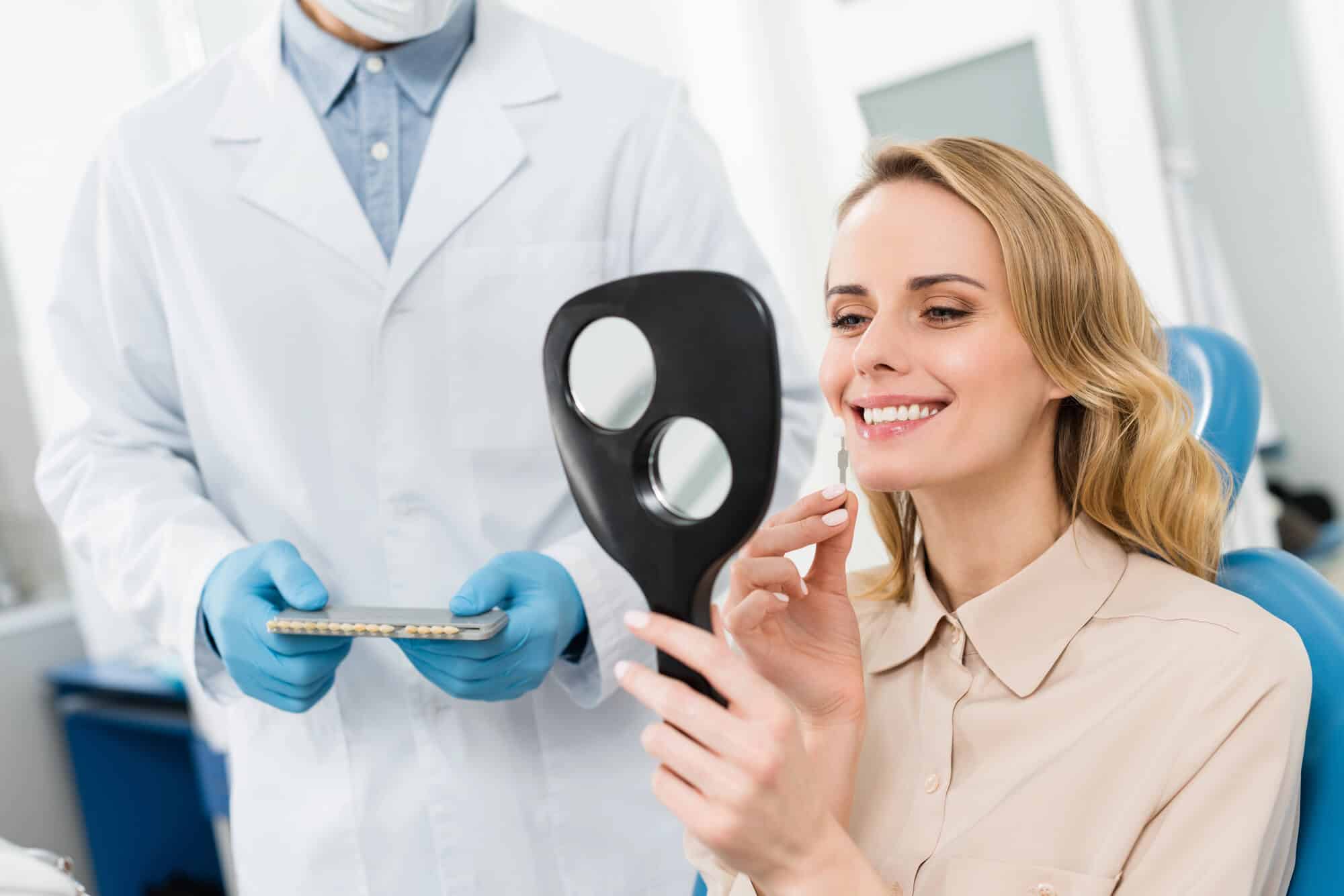 Patient reviewing her new tooth color with a dentist